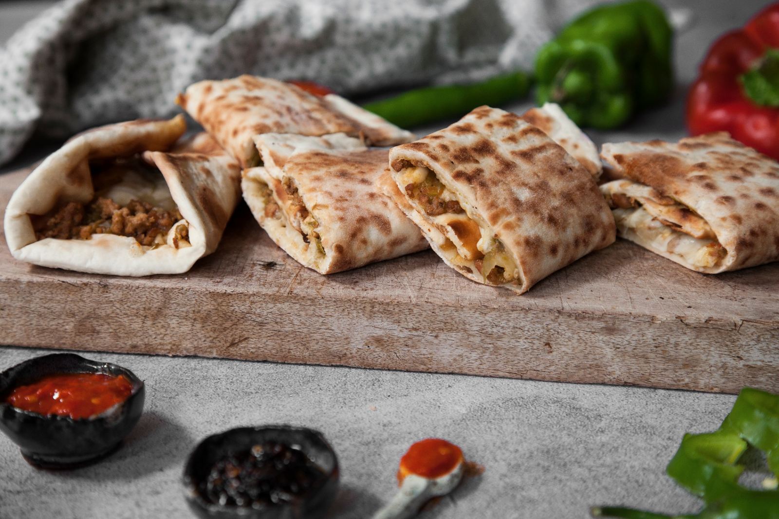 Meat and cheese arayes on a wooden board
