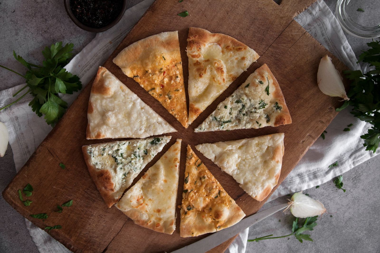 Cheese pizza slices on a rustic board